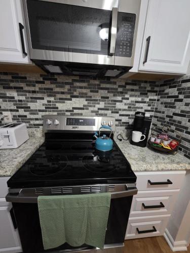 a kitchen with a stove and a microwave at Charming 3 bedrooms in the heart of Alpharetta in Alpharetta