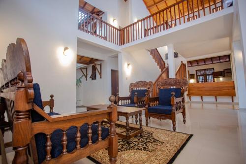 a living room with a dining room table and chairs at Sea Breeze Coast - Stay in Kamburugamuwa