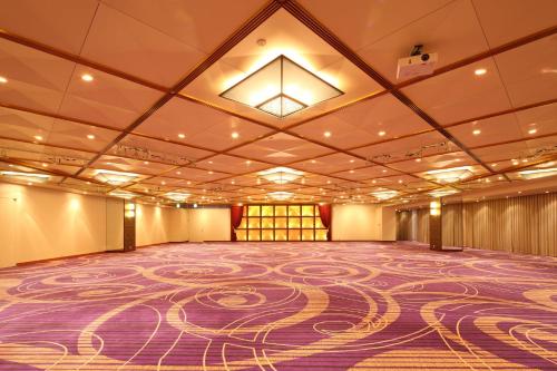 a large ballroom with a purple carpet on the ceiling at RIHGA Royal Hotel Osaka, Vignette Collection by IHG in Osaka