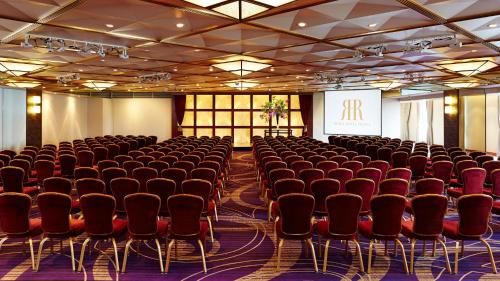 a conference room with chairs and a screen in the middle at RIHGA Royal Hotel Osaka, Vignette Collection by IHG in Osaka