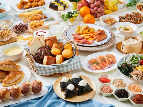 a table with many plates of food on it at Hotel Universal Port in Osaka
