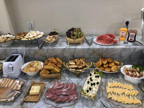 a table topped with lots of different types of food at Beksaroy in Samarkand