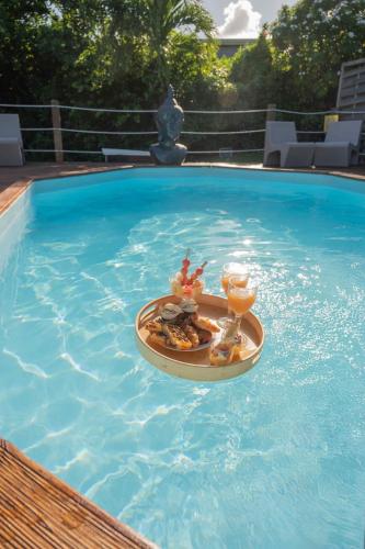 a tray of food and drinks in a swimming pool at Exotic Villa avec Piscine in Le Vauclin