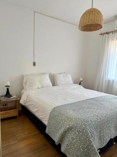 a bedroom with a large bed and a night stand at Best location ! Apt privado 2 hab con AC Completamente equipado en Asuncion in Asuncion