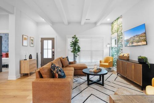 a living room with a couch and a table at Near BoA Stadium, 5 Bedroom with Games, Backyard in Charlotte
