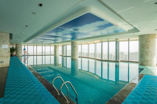 a swimming pool with a view of the city at Hilton Fuzhou in Fuzhou
