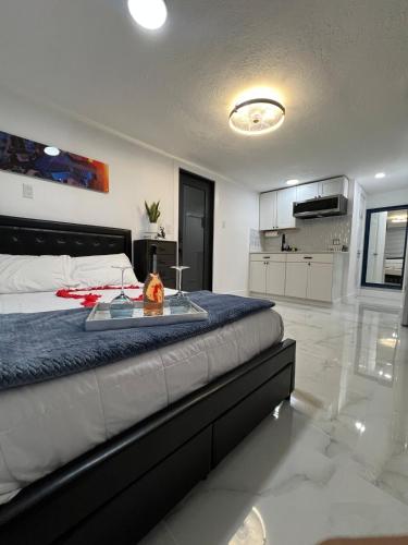 a bedroom with a bed with a tray on it at AMIRI Hollywood 5 mins from Hard Rock Stadium & The Guitar in Hollywood