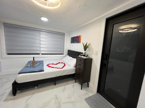 a bedroom with a bed and a window at AMIRI Hollywood 5 mins from Hard Rock Stadium & The Guitar in Hollywood