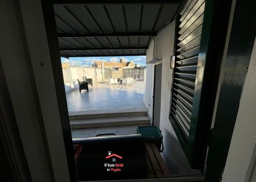 an open door to a balcony with a view of a porch at Casa Bianca bnb,Big Terrace,10 min Airport Beaches in Bitonto