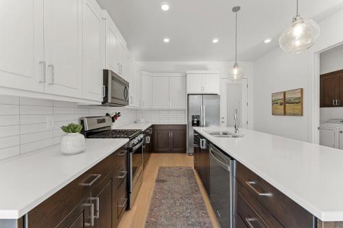 a kitchen with white counter tops and wooden cabinets at Villa #19 at Bloomington Country Club condo in St. George