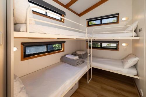 a small bedroom with bunk beds in a tiny house at BIG4 Swan Hill in Swan Hill