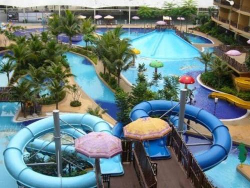 a pool at a resort with a water park at sunset studio apartment At Goldcoast morib in Banting