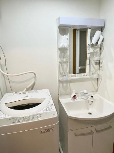 a bathroom with a toilet and a sink at Lucky House 喜屋 in Osaka
