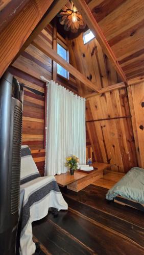 a room with a bed and a window in a cabin at tropical garden homestay in Lien Khuong Airport