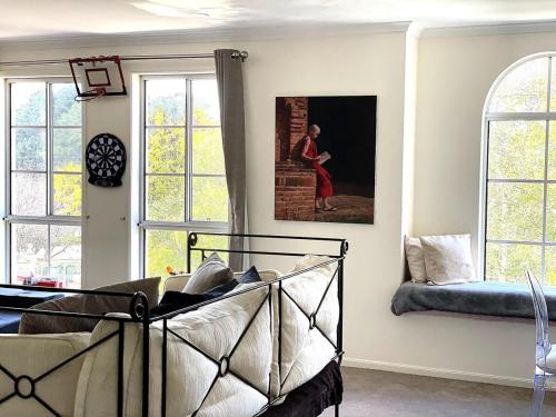 a room with a bed and a painting on the wall at Beautiful Home Away From Home in Bowral in Bowral