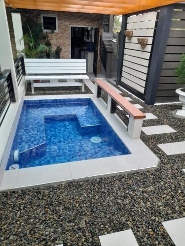 a swimming pool in the middle of a patio at BIDESI VILLA Apartments in Suva