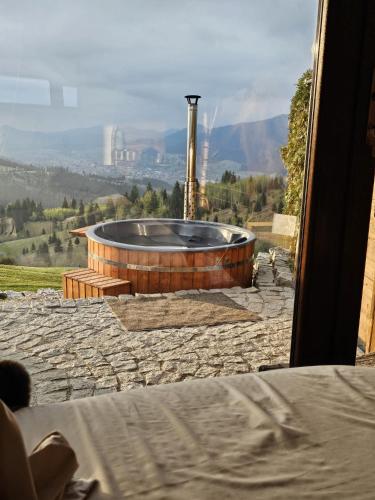 a hot tub sitting on top of a stone patio at Palazzo Transylvania-Bran in Sohodol