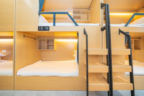 a group of bunk beds in a dorm room at Dengba Inn-Shanghai New World Plaza Branch in Shanghai