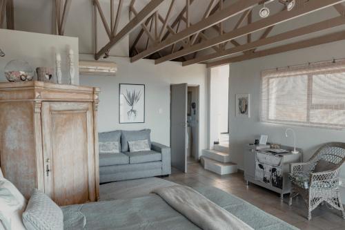 a living room with a couch and a table at The Ocean Bay Luxury Guesthouse in Jeffreys Bay