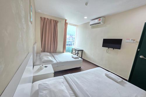 Postel nebo postele na pokoji v ubytování Fast Hotel Sri Gombak