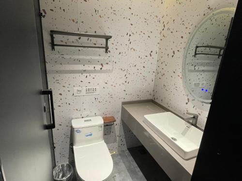 a small bathroom with a toilet and a sink at Dengba Inn-Shanghai New World Plaza Branch in Shanghai