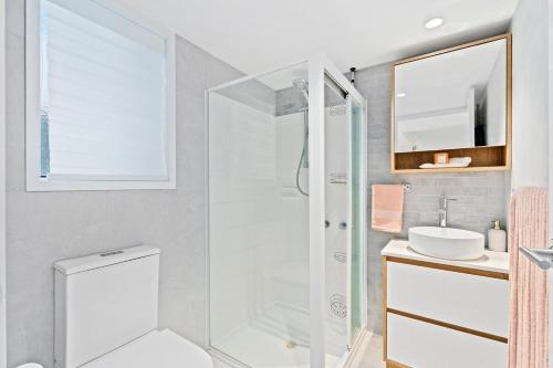 a bathroom with a shower and a toilet and a sink at Coastline Escape Renovated Unit - Great Location - Quiet Area - Parking Included in Gold Coast