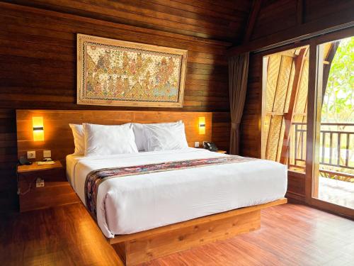 a bedroom with a large bed in a room at Adil Villa & Resort in Ubud