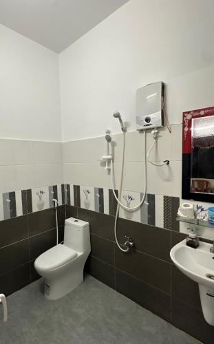a bathroom with a toilet and a sink at Khách Sạn Trang Thư in Quang Ngai