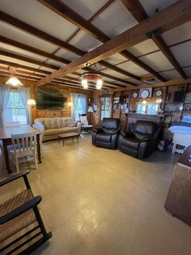 a large living room with couches and a table at FLETCHER LIMIT 8 cottage in Standish