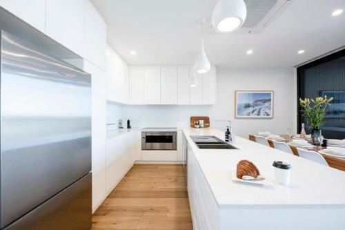 a kitchen with white cabinets and a white counter top at Anglesea Coastal Getaway - Prime Location in Anglesea