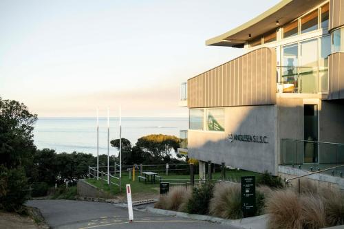 a building with the ocean in the background at Anglesea Coastal Getaway - Prime Location in Anglesea