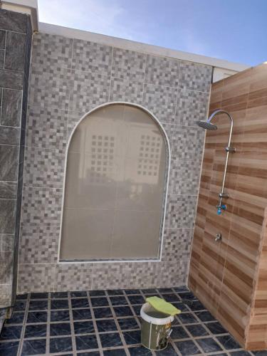 a shower with a glass door in a bathroom at Buketree homestay satun in Ban Khok