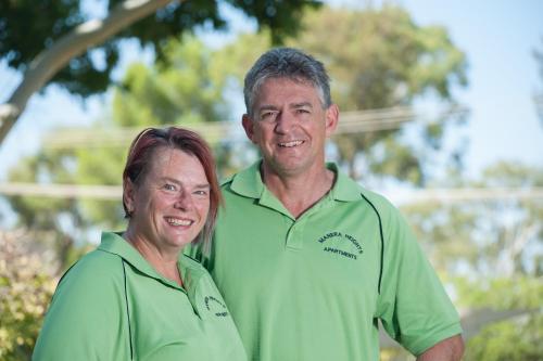 a man and a woman standing next to each other at Manera Heights Apartments in Dubbo