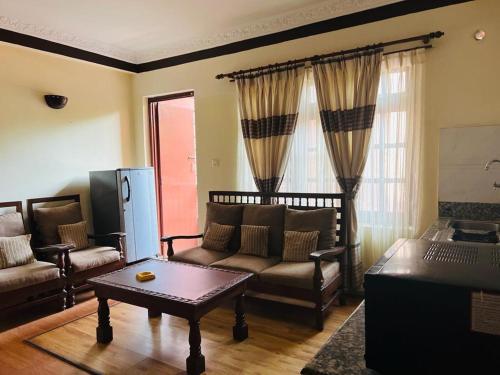 a living room with a couch and a coffee table at Nest apartment in Kathmandu