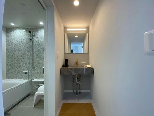 a bathroom with a sink and a shower at The land hotel L5 in Arao