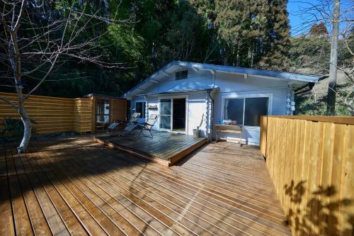 a large wooden deck in front of a house at vihrea in Ōtaki