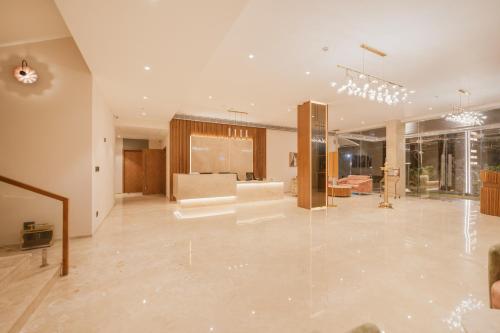a large living room with a couch and a table at Loft Business Hotel in Kakkanad