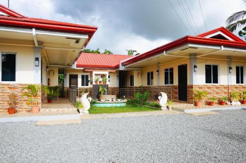 a home with a red roof at AJ Residences Apartelle Camotes RedPartner in Esperanza