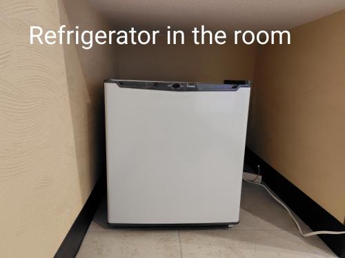 a white refrigerator in the corner of a room at Wa no oto 和の音交流館 鬼怒川宿 in Nikko