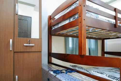 a bedroom with two bunk beds in a room at AJ Residences Apartelle Camotes RedPartner in Esperanza