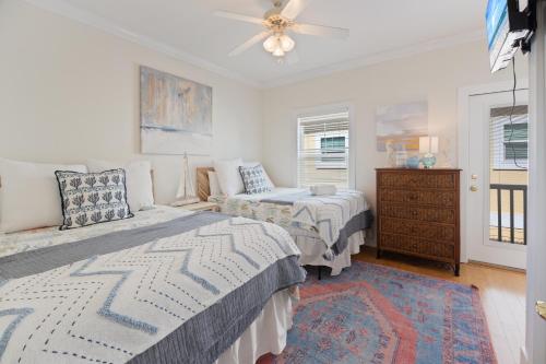 a bedroom with two beds and a ceiling fan at Captain's Chair 18A By Pkrm in Pensacola
