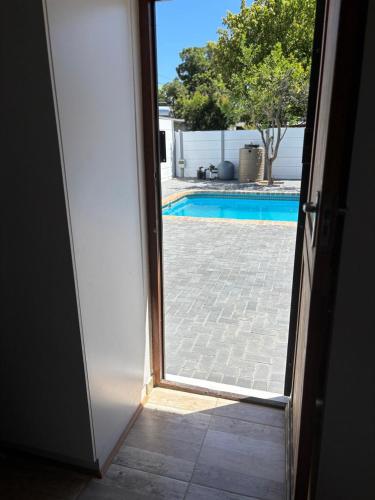 an open door with a view of a swimming pool at 30 on 6th in Bellville