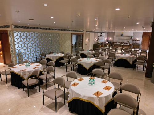 a banquet hall with tables and chairs in a restaurant at Clarks Collection Grand Sapphire Ajmer in Ajmer