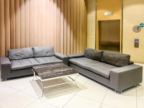 a living room with a couch and a coffee table at KidsVille Slide PlayNest at Afiniti, Walking to Legoland JB, Johor, Malaysia in Iskandar Puteri