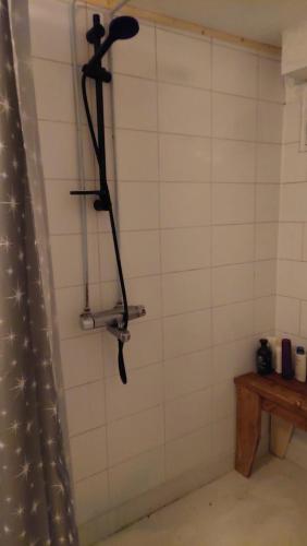 a shower head hanging on the wall of a bathroom at Arctic Landhaus in Sotkamo