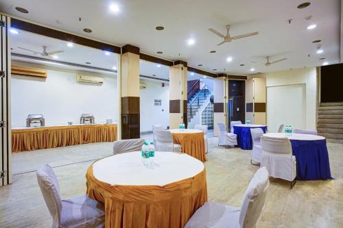 a conference room with tables and chairs and a stage at New Ammby Inn - Lajpat Nagar in New Delhi