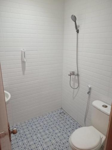 a bathroom with a shower and a toilet at Hotel Rimadi in Jakarta