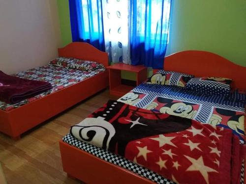two beds sitting in a room with at Pine Valley Homestay in Padamchen