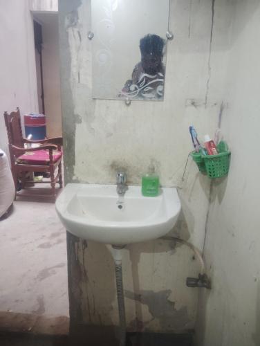 a bathroom with a sink and a picture of a dog at Chauhans house in Prayagraj
