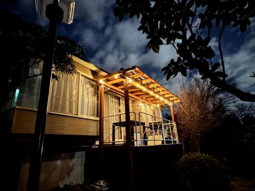 a house with lights on the front of it at コテージ大室山 in Ito